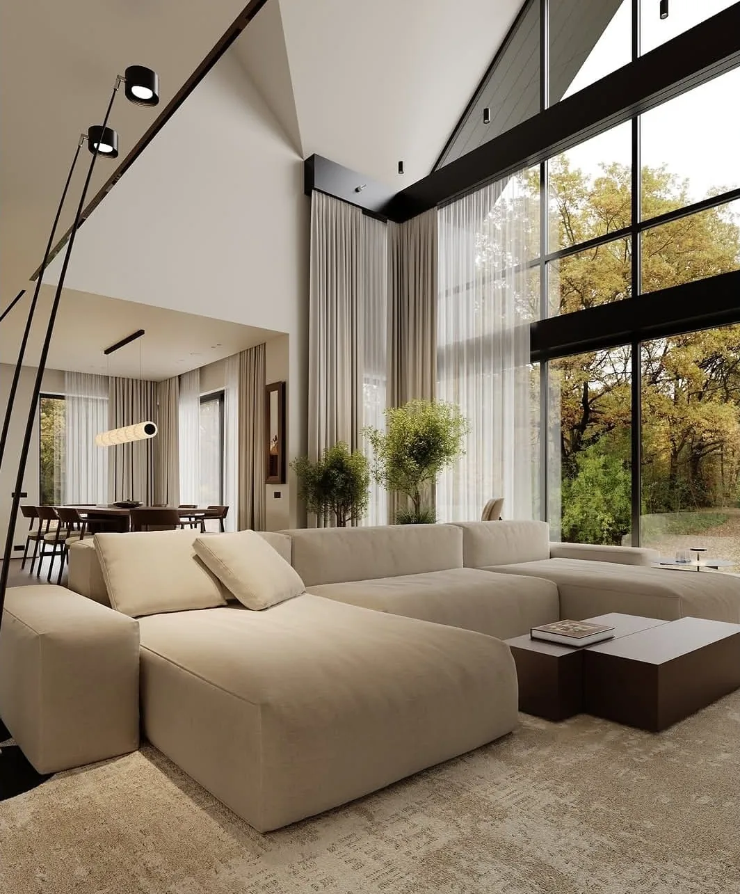 Vue 3D d'un séjour double hauteur avec canapé d'angle beige et baies vitrées toute hauteur sur un parc